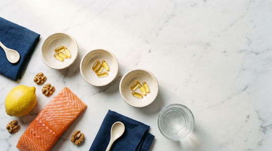 Three dishes of golden softgels with salmon and lemon on marble for a Nordic vs Carlson vs Thorne fish oil comparison